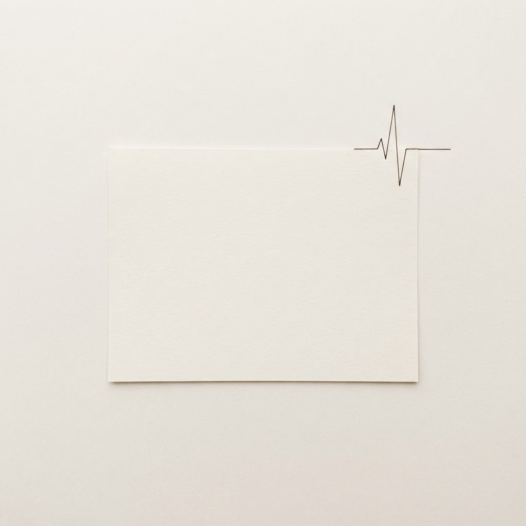Line illustration of a single sheet of paper with a small pulse rising from its edge